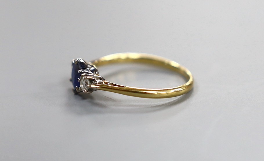 An 18ct & plat, sapphire and diamond set three stone ring, size O, gross weight 2 grams.